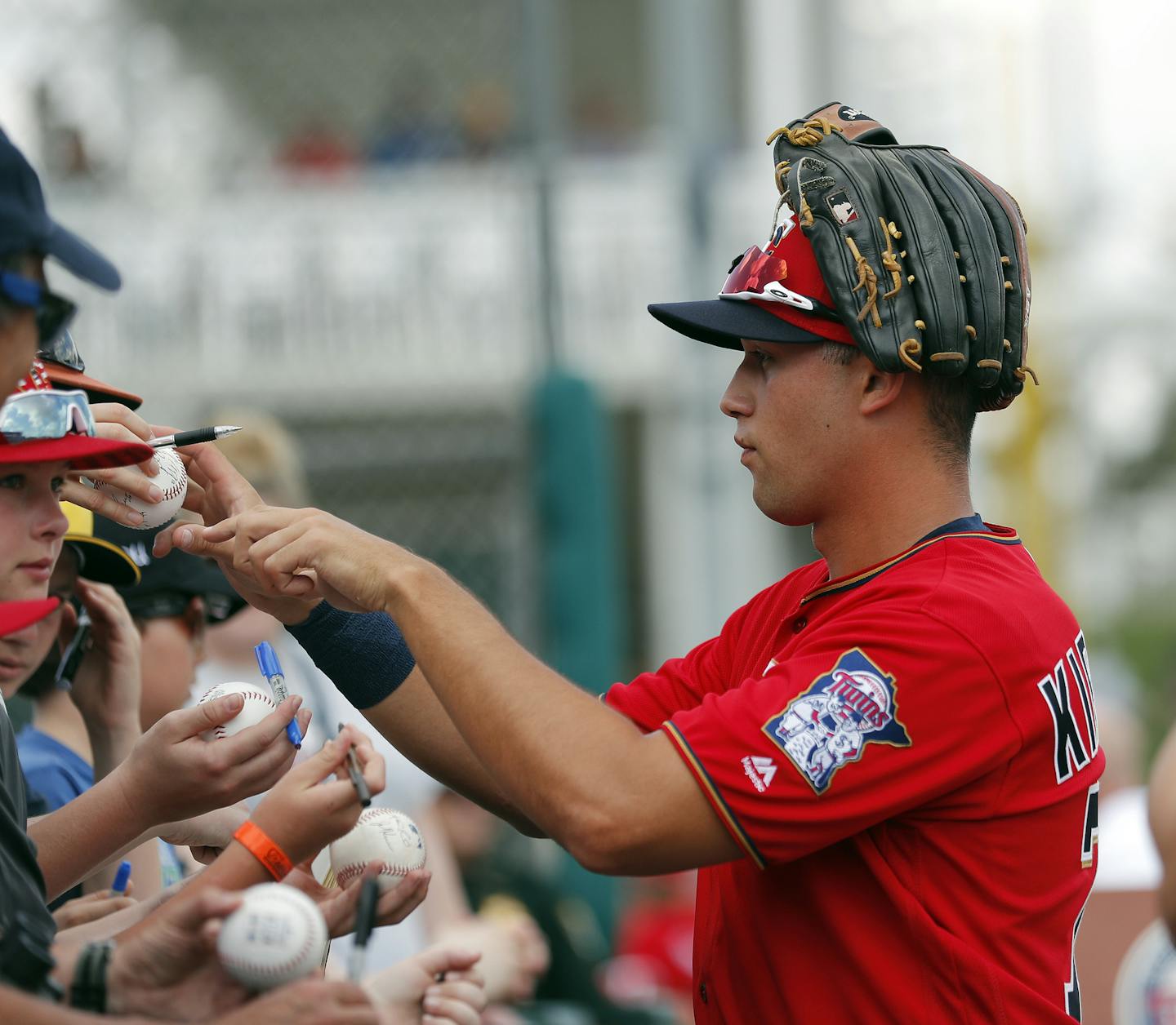 Minnesota Twins right fielder Alex Kirilloff signs autographs before the start of inning of a spring training baseball game against the Baltimore Orioles Monday, March 4, 2019, in Fort Myers, Fla. (AP Photo/John Bazemore) ORG XMIT: GAJB102