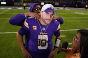 Kirk Cousins gets presented with new bling by Justin Jefferson during a postgame interview after the 22-17 victory over the 49ers.