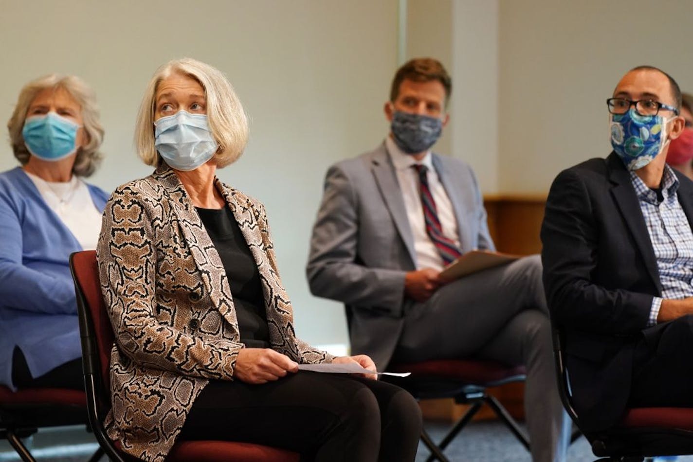 From left, Department of Health Commissioner Jan Malcolm, Dr. Leslie Baken, an infectious disease specialist at North Memorial Health, Department of Employment and Economic Development Commissioner Steve Grove, and Dr. Dimitri Drekonja, an infectious disease specialist and associate professor at the University of Minnesota, all wore masks as they listened to Gov. Tim Walz announce a statewide mask mandate to help slow the spread of COVID-19 Wednesday.