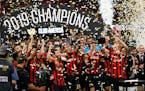 Atlanta United team members celebrate with the trophy after defeating Club America 3-2 in the Campeones Cup soccer final Wednesday, Aug. 14, 2019, in 