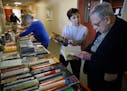 Robin White helps Stephen Spielberg,84 browse through the books she has set out at Knollwood Place Apartments. Spielberg, a retired mathematician is a