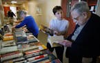 Robin White helps Stephen Spielberg,84 browse through the books she has set out at Knollwood Place Apartments. Spielberg, a retired mathematician is a