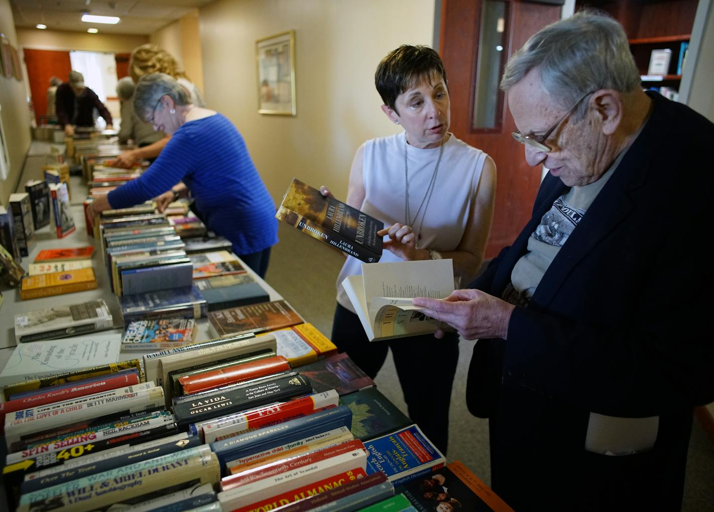 Robin White helps Stephen Spielberg,84 browse through the books she has set out at Knollwood Place Apartments. Spielberg, a retired mathematician is an avid reader.] At Knollwood Place Apartments, Robin White gathers book donations and recycles them at free book fairs at senior residences for her nonprofit Green Books.RICHARD TSONG-TAATARII &#xa5; richard.tsong-taatarii@startribune.com