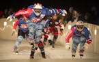 Daniel Bergeson left, with Team Murica , catches some air while racing against Team Quebec in the semifinals of the Crashed Ice team competition in Ja