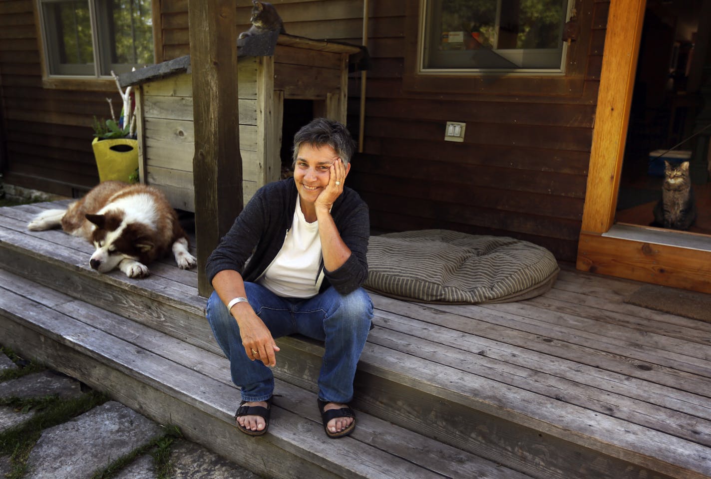 Ann Bancroft and her dog, Scissors, relax on the front porch at her farmhouse on the St. Croix River.