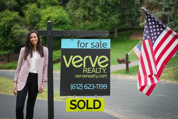 Realtor Mitra Rahimi stands in front an Eden Prairie home that sold in two days after having 28 showings and receiving eight offers.