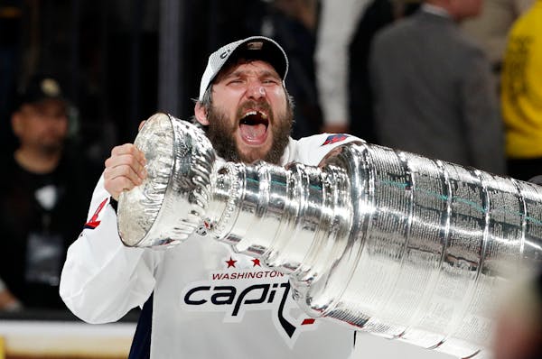 Washington Capitals left wing Alex Ovechkin, of Russia, hoists the Stanley Cup after the Capitals defeated the Golden Knights in Game 5 of the NHL hoc