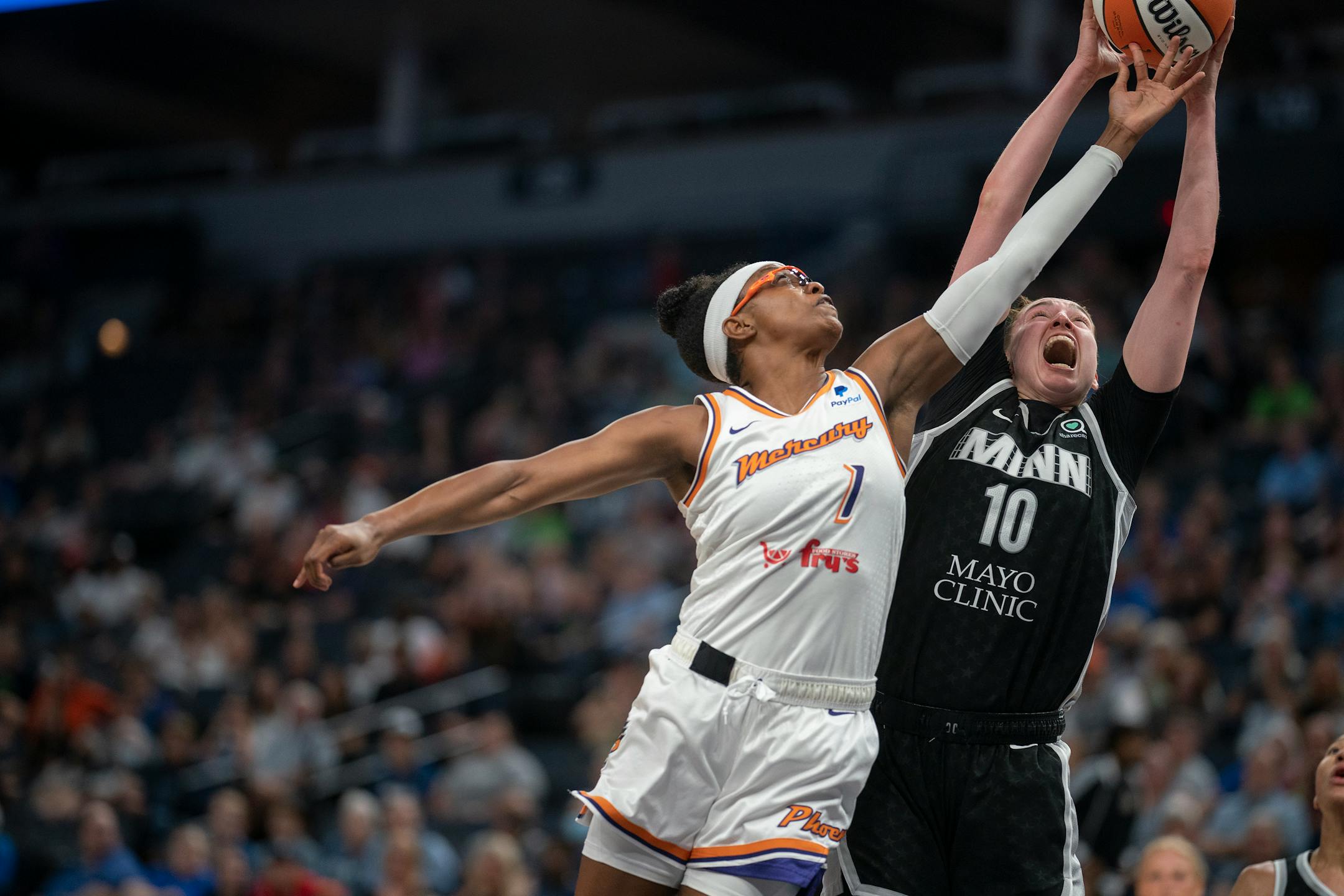 Minnesota Lynx forward Jessica Shepard (10) pulls down a rebound over Phoenix Mercury guard Diamond DeShields (1) in the second half.