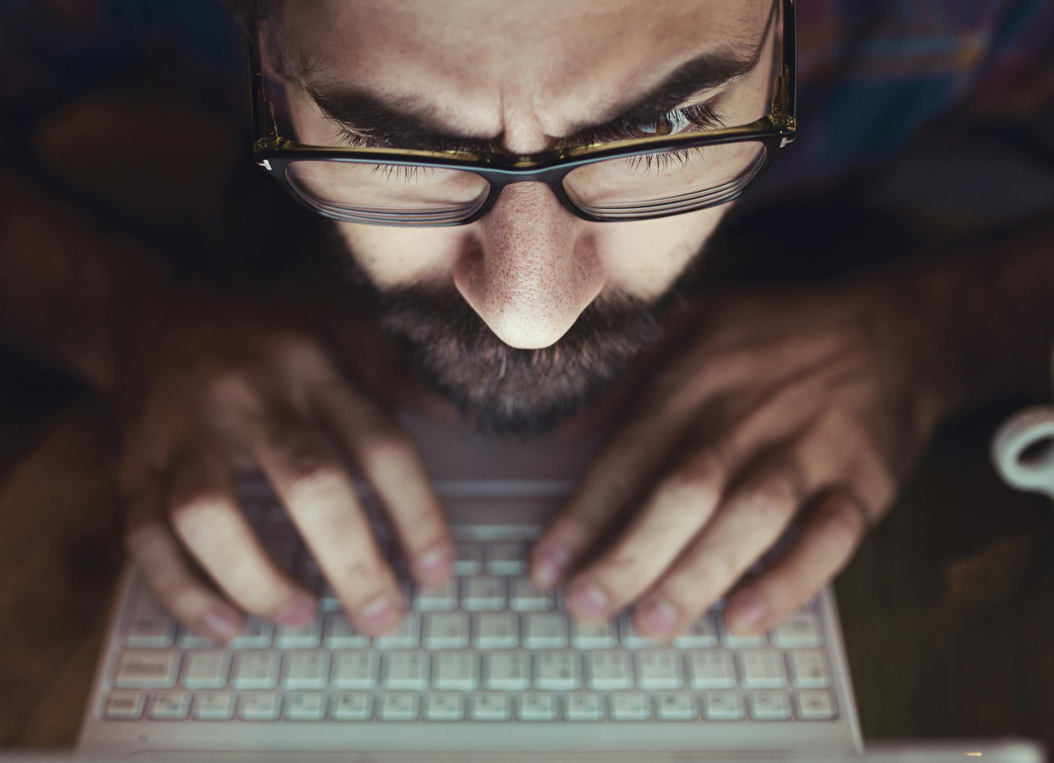 Computer hacker stealing information with laptop