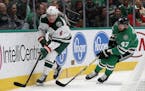Minnesota Wild center Ryan Donato (6) controls the puck as Dallas Stars right wing Alexander Radulov (47) gives chase in the second period of an NHL h