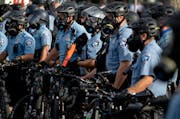Police gather en masse as protests continue at the Minneapolis 3rd Police Precinct, Wednesday, May 27, 2020, in Minneapolis. 