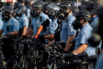 Police gathered en masse as protests continued at Minneapolis’ third police precinct headquarters on May 27, 2020.