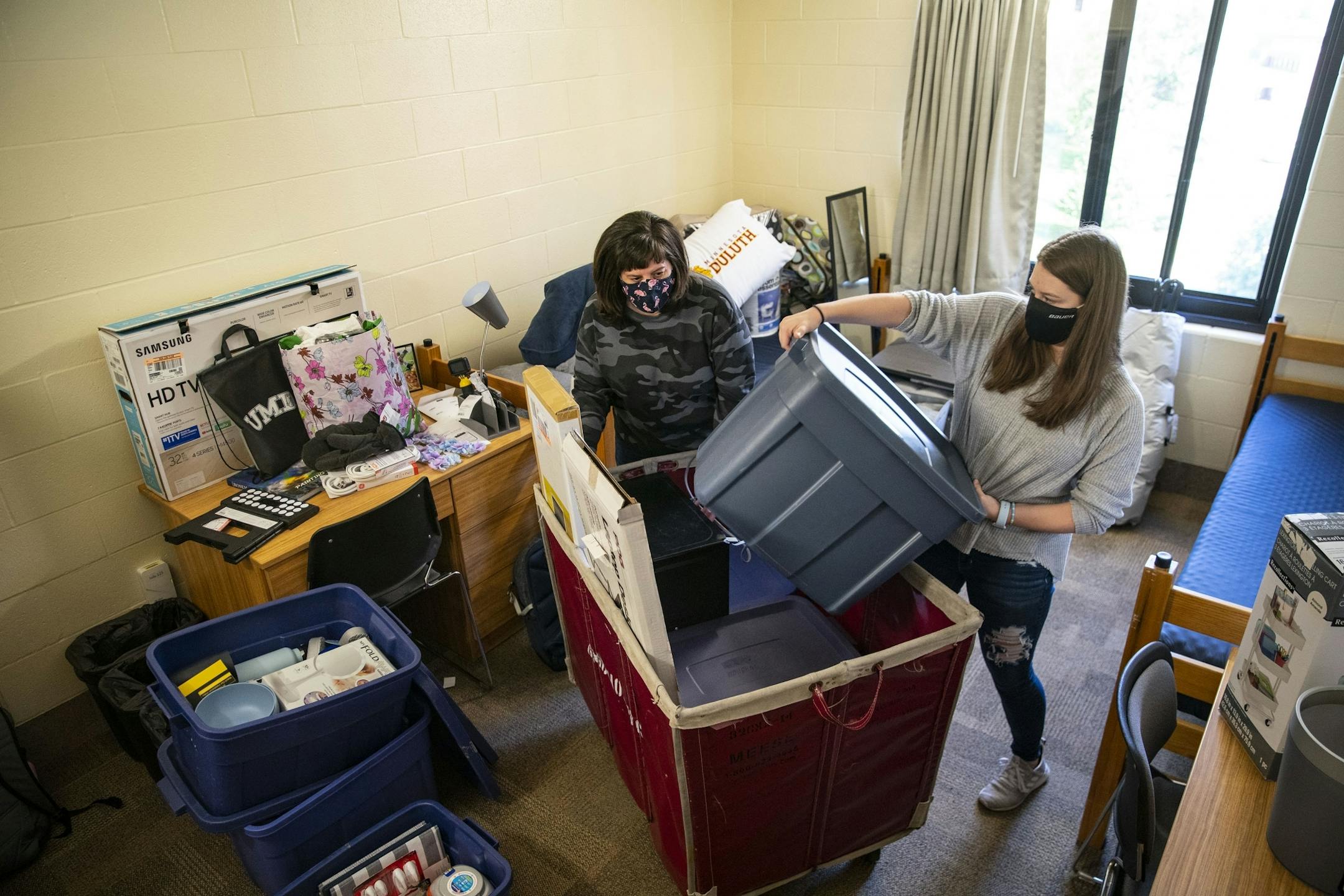Riley Krenz, an freshman Chemistry major from Rosemount, MN, and her mother, Molly, began unpacking the second of three carts with her belongings as they moved Riley into her room in Ianni Hall at UMD on Thursday.
