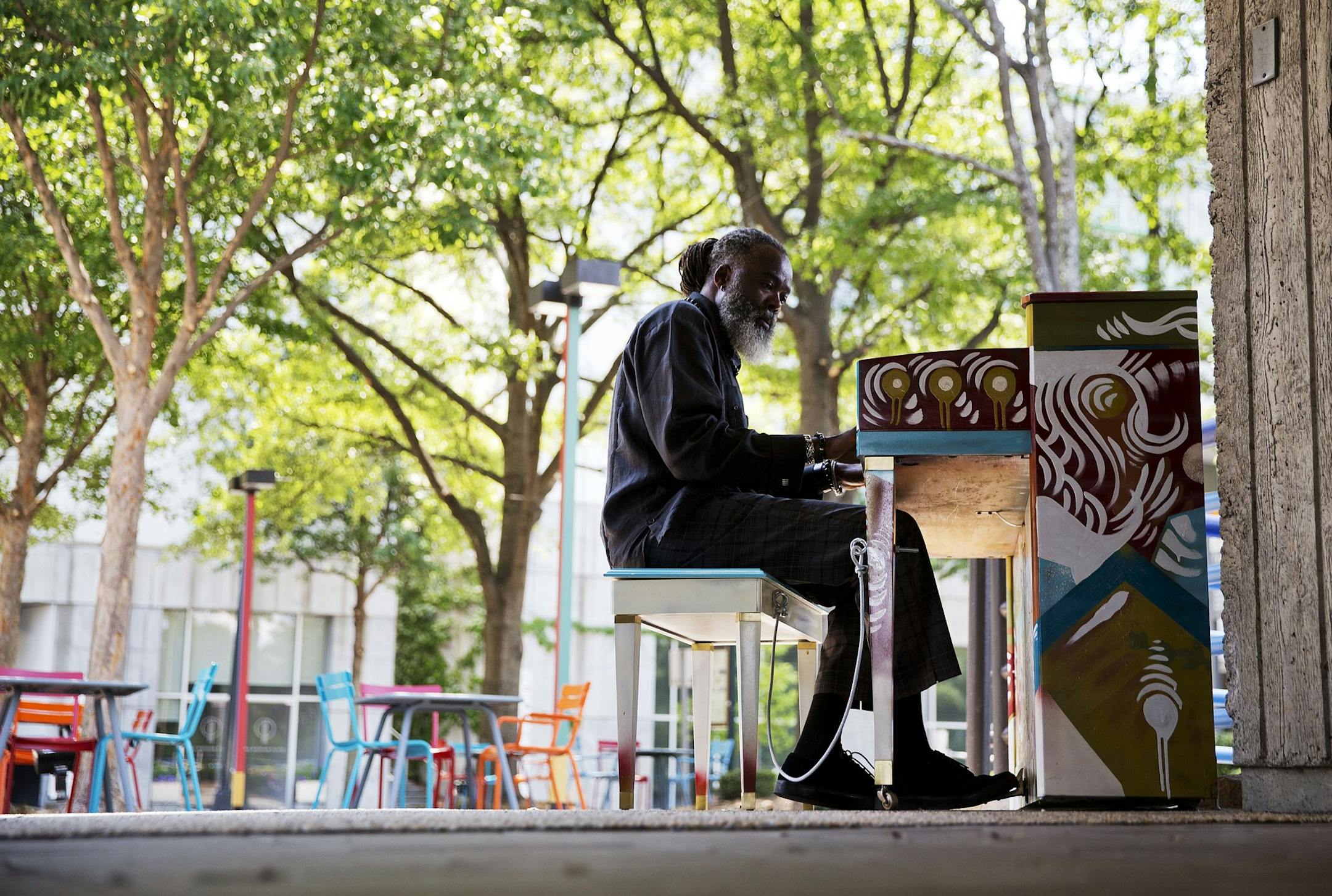 Audy Maxineau plays a public piano outside the MARTA public transportation station on his lunch break from working at the nearby High Museum of Art Friday, June 3, 2016, in Atlanta. "I've seen these pianos in other cities and always wished they would do it here," said Maxineau. "Then I come to work this morning and here it is. I will be here every day on my lunch break now." (AP Photo/David Goldman) ORG XMIT: GADG102