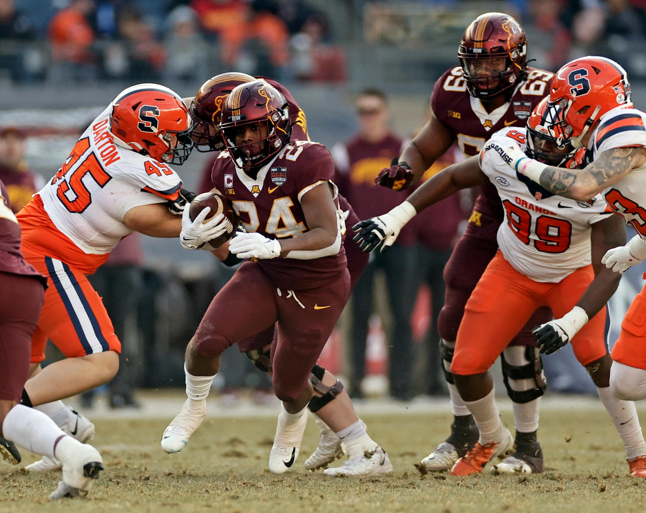 Minnesota running back Mohamed Ibrahim (24) runs past Syracuse defensive back Justin Barron (23) during the first half.