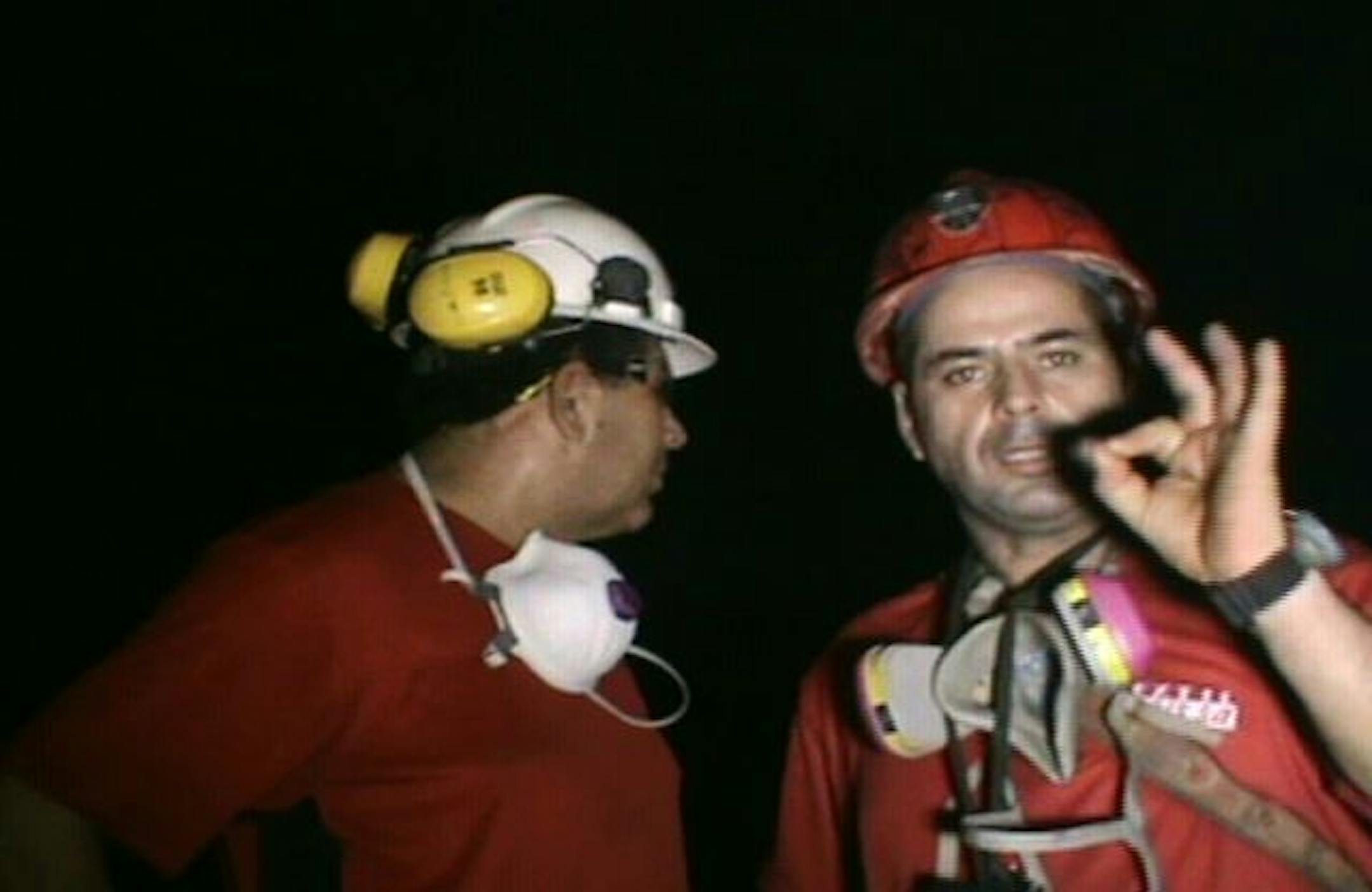 In this TV frame grab released by Chile's government, miners Mario Sepulveda, right, and Luis Urzua are seen in the collapsed San Jose mine.