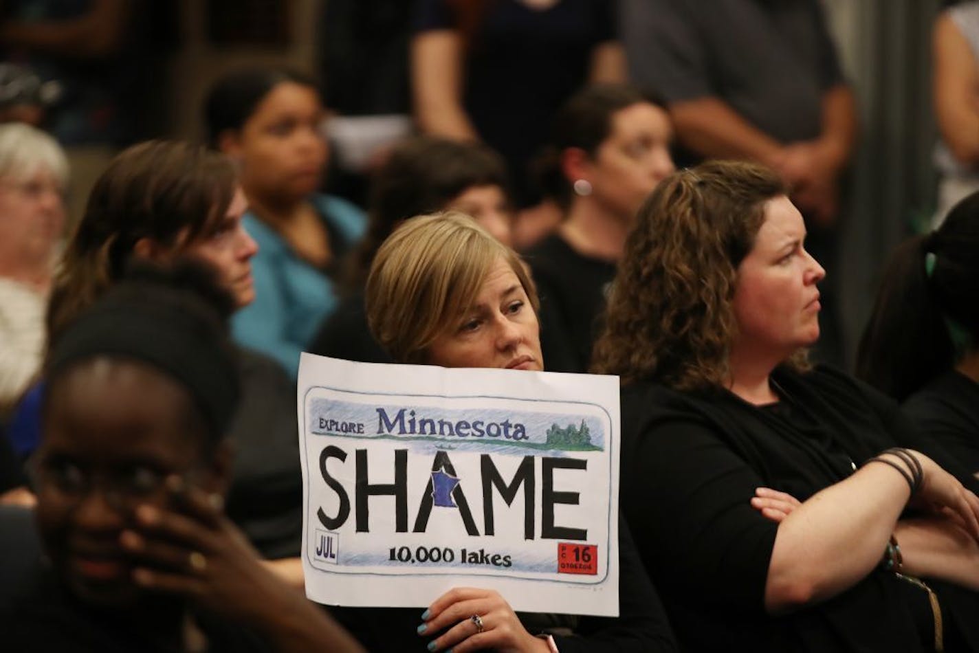 Katy Cummins-Bakko of St. Paul listens as protester spoke to St. Anthony City Council members about racial profiling Tuesday, June 27, 2017 in St. Anthony, MN.