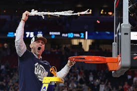 Connecticut coach Dan Hurley cuts down the net after the Huskies beat Purdue 75-60 to win the NCAA men's Final Four on April 8 in Glendale, Ariz.