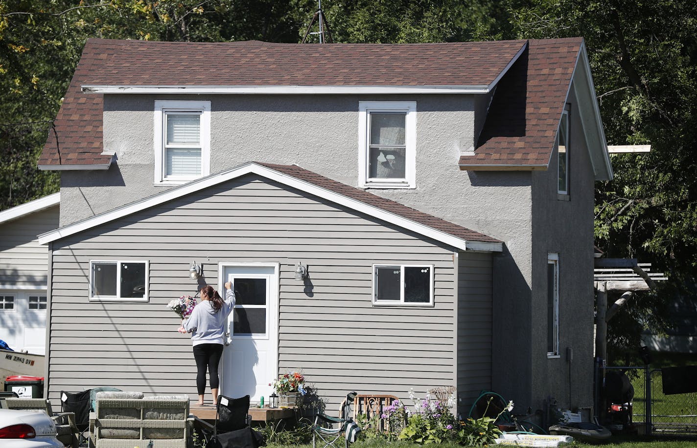 A woman carrying flowers and balloons to the home on Meeker Street were 5-year old Alayna Ertl lived Monday August 22 2016 in Watkins, MN.] Alayna funeral will be held Friday at the Church of St. Anthony in Watkins. Jerry Holt / jerry.Holt@Startribune.com