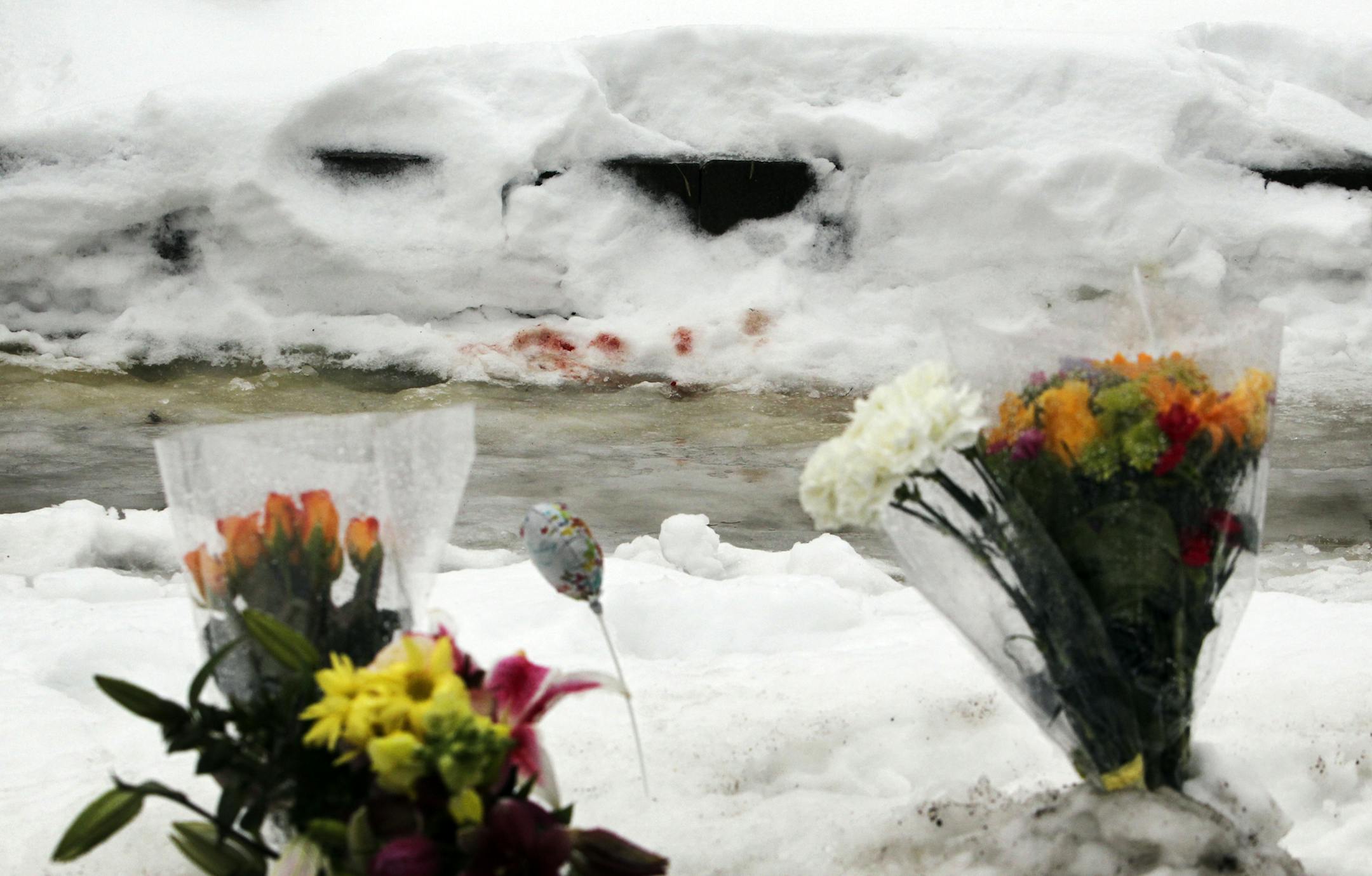 Blood in the snow near a makeshift Memorial outside the North Side venue that had been operating illegally as an after-hours club where two men were shot and killed early Friday morning.] (DAVID JOLES/STARTRIBUNE) djoles@startribune.com Blood in the snow near a makeshift Memorial outside the North Side venue that had been operating illegally as an after-hours club where two men were shot and killed early Friday morning.