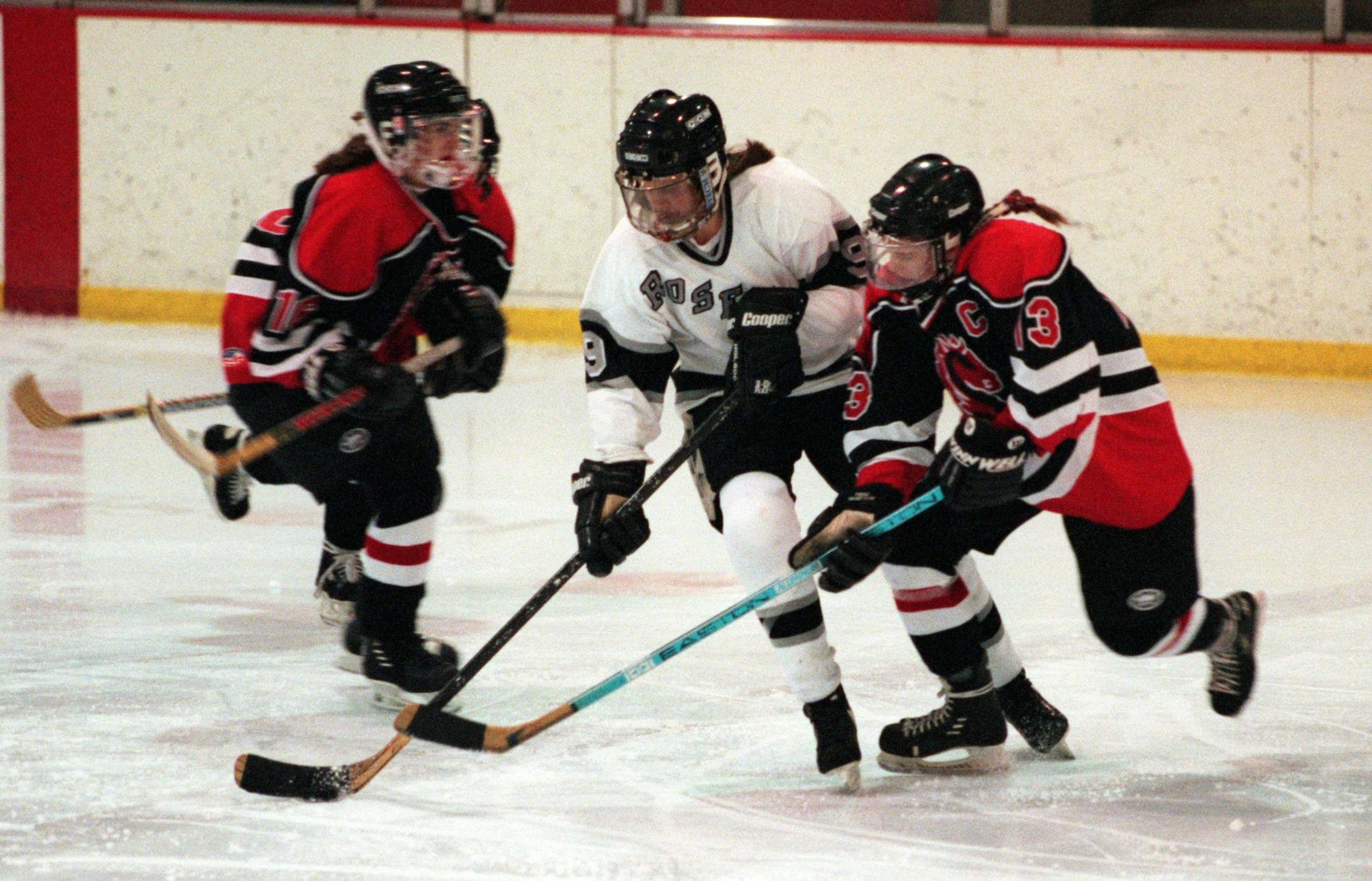 Defending state champion Roseville took on Stillwater in hockey Monday night at Roseville Arena. -- Roseville√ås Ronda Curtin stickhandles between a couple of Stillwater defenders during a game last December at the Roseville Ice Arena.