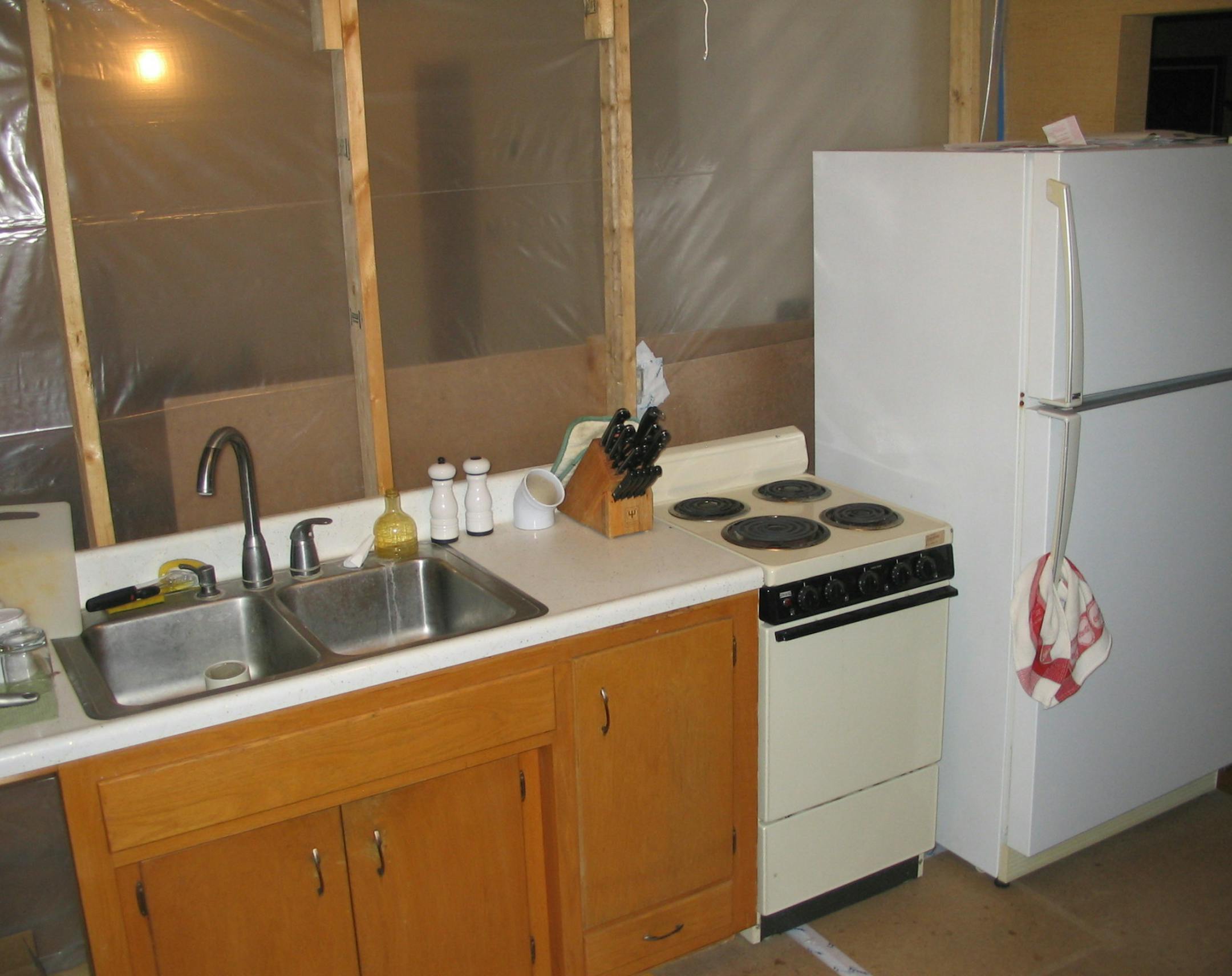 Temporary kitchens, such as this one set up by Sylvestre Remodeling & Design, often make use of the old appliances.