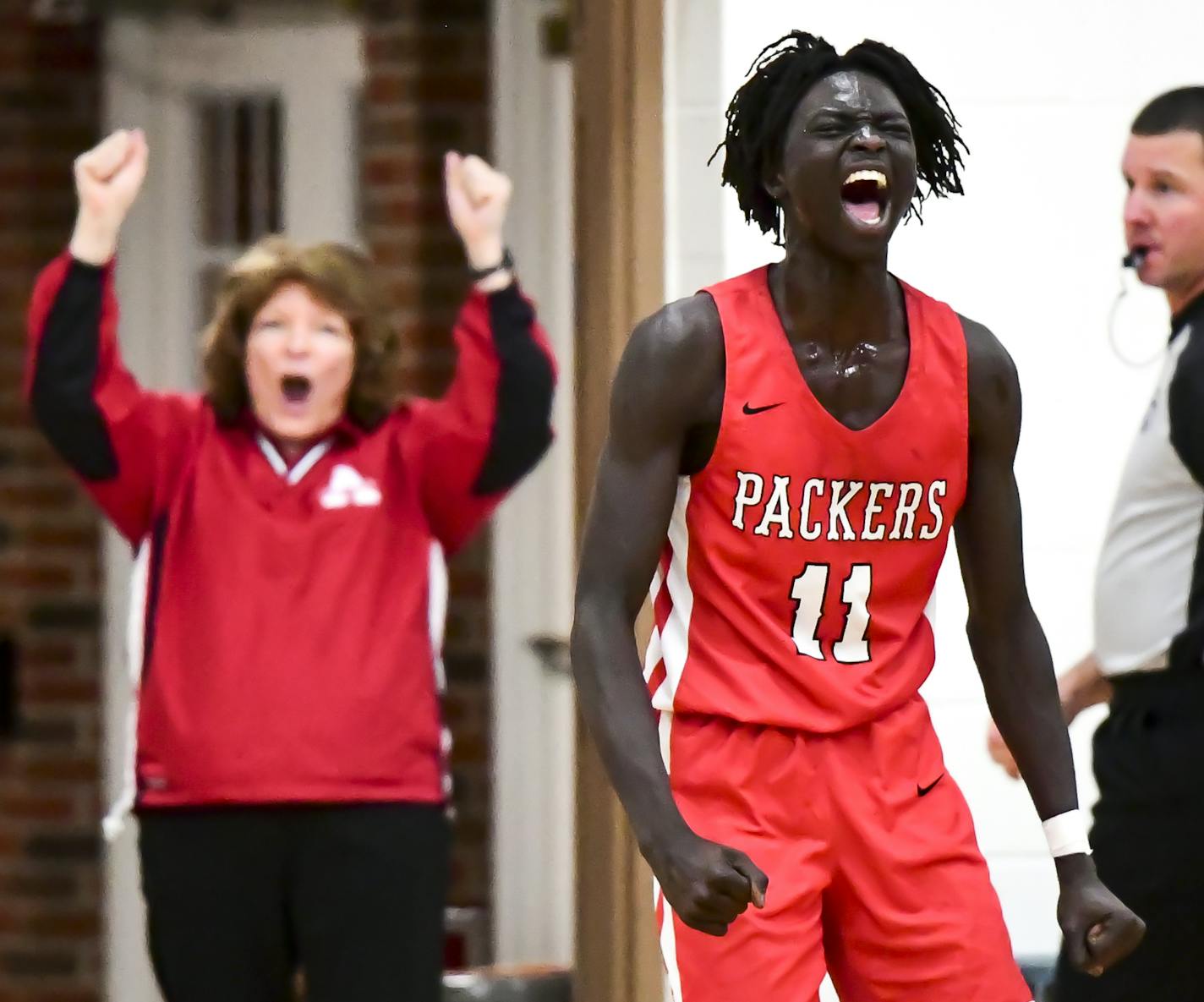 Agwa Nywesh celebrated a basket scored against John Marshall during the first half Tuesday night at Austin High School. ] Aaron Lavinsky &#x2022; aaron.lavinsky@startribune.com Photos to accompany a feature on the ethnic diversification of Austin Minn., as seen through the Austin High School boys basketball and soccer programs, photographed Tuesday, Dec. 17, 2019.