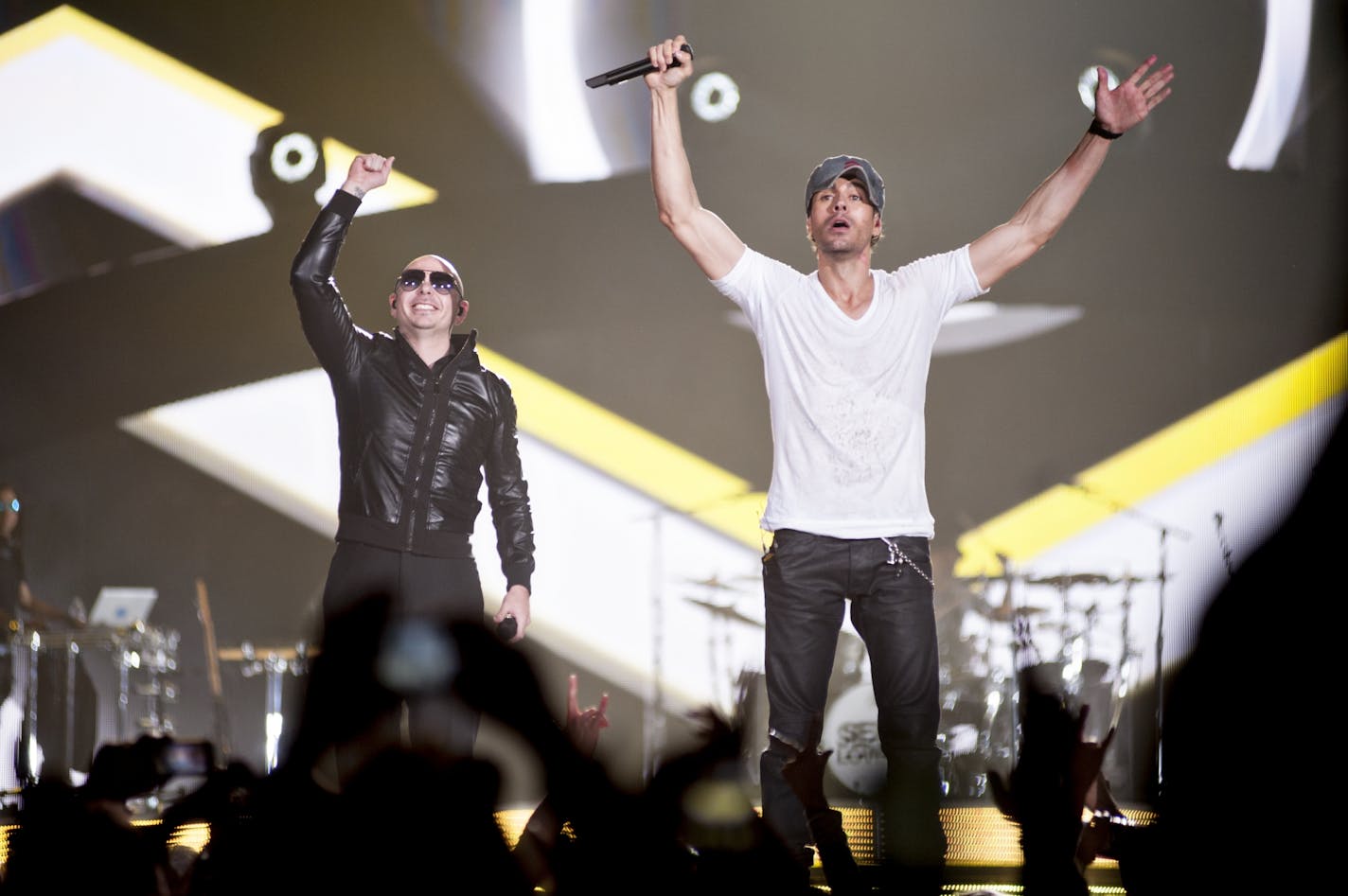 Pitbull, left, and Enrique Iglesias perform during their encore at the Target Center on February 21, 2015.