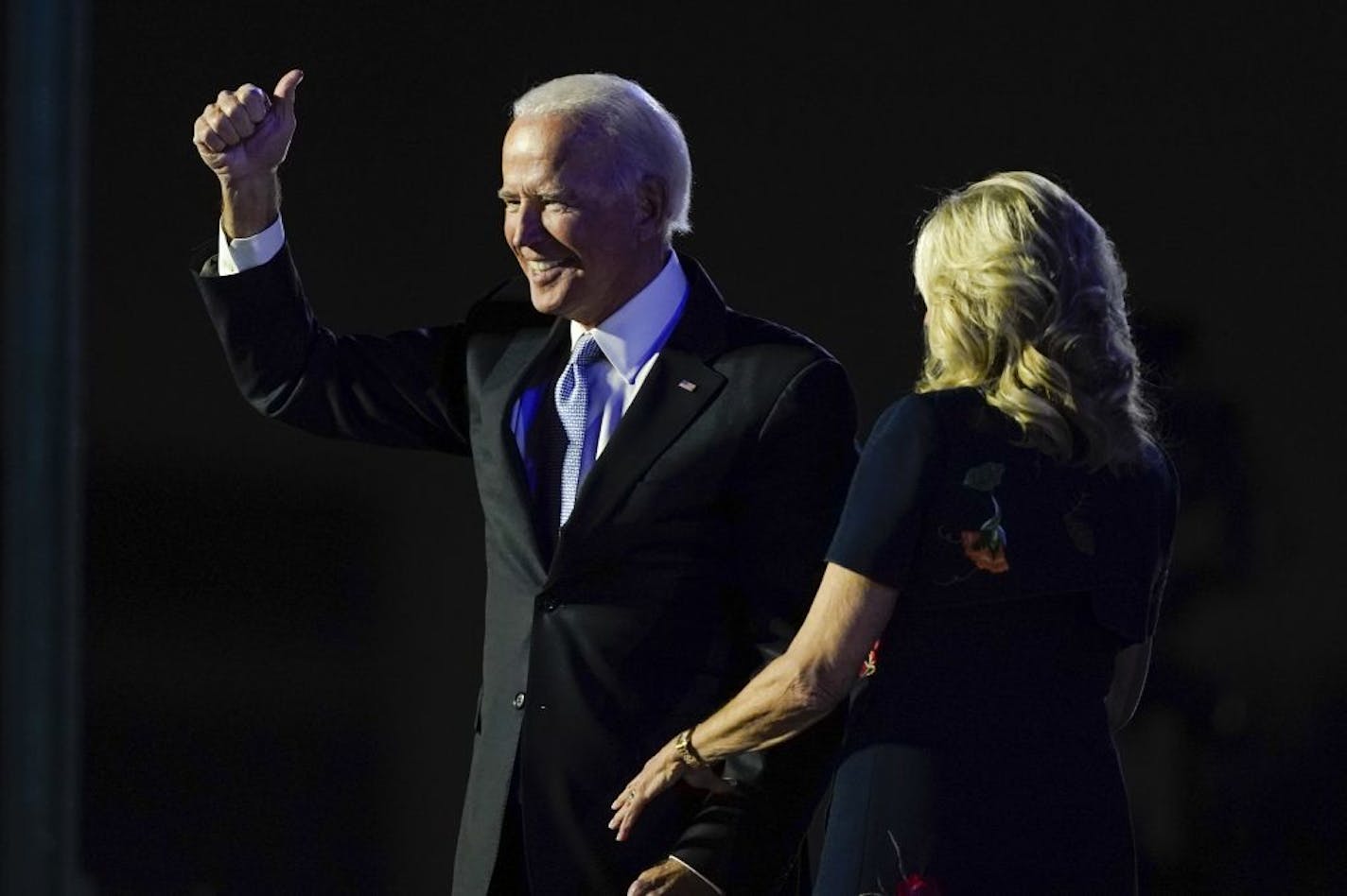 President-elect Joe Biden stands on stage with his wife Jill Biden Saturday, Nov. 7, 2020, in Wilmington, Del.