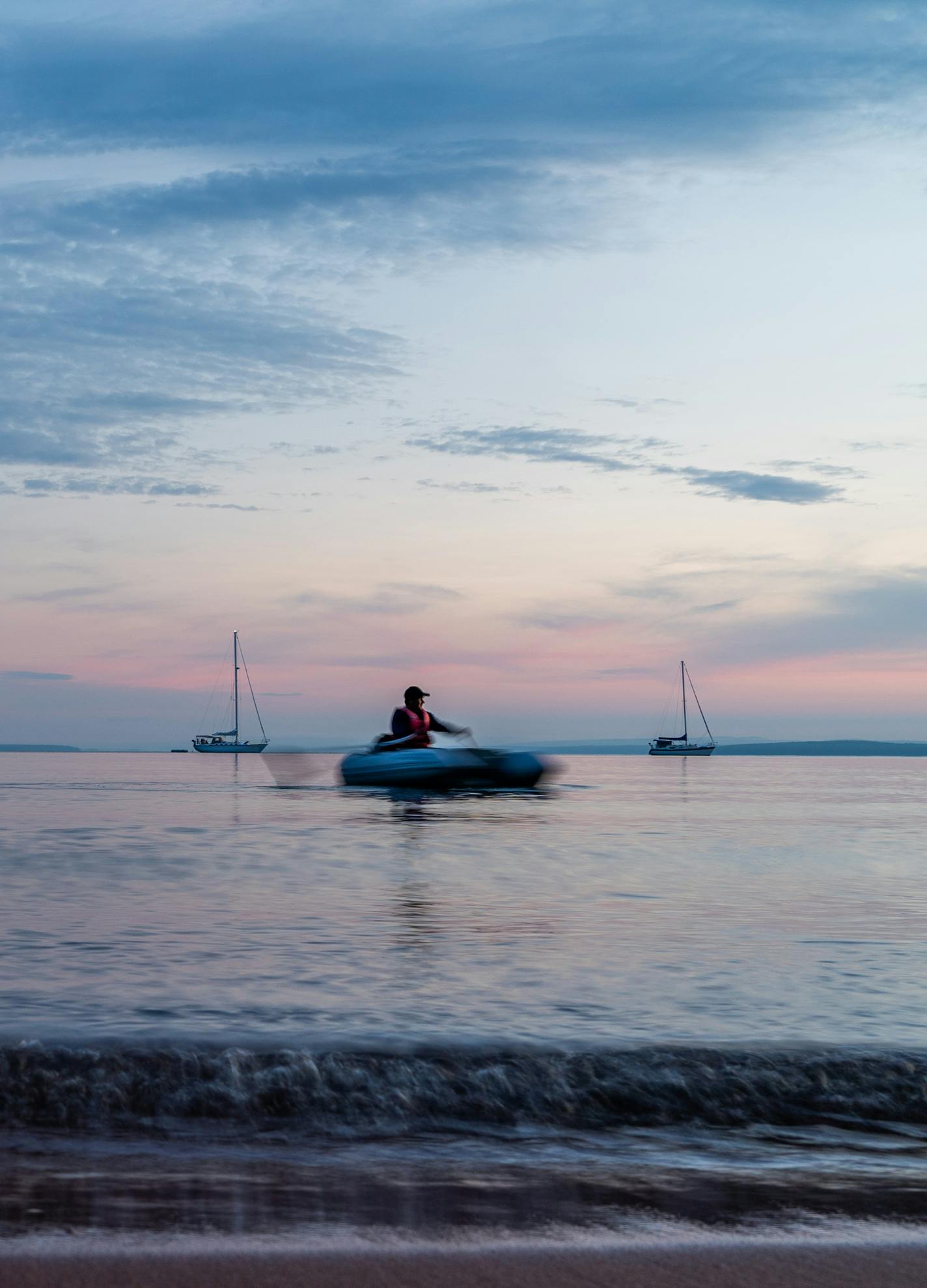 A visitor retunes to his boat on Presque Isle Bay after taking his dog for an evening shore walk. ] MARK VANCLEAVE &#xa5; The Apostle Islands National Lake Shore covers 21 islands on Wisconsin's south shore of Lake Superior. Photographed Saturday, Aug 3, 2019 in the Apostle Islands National Lake shore.