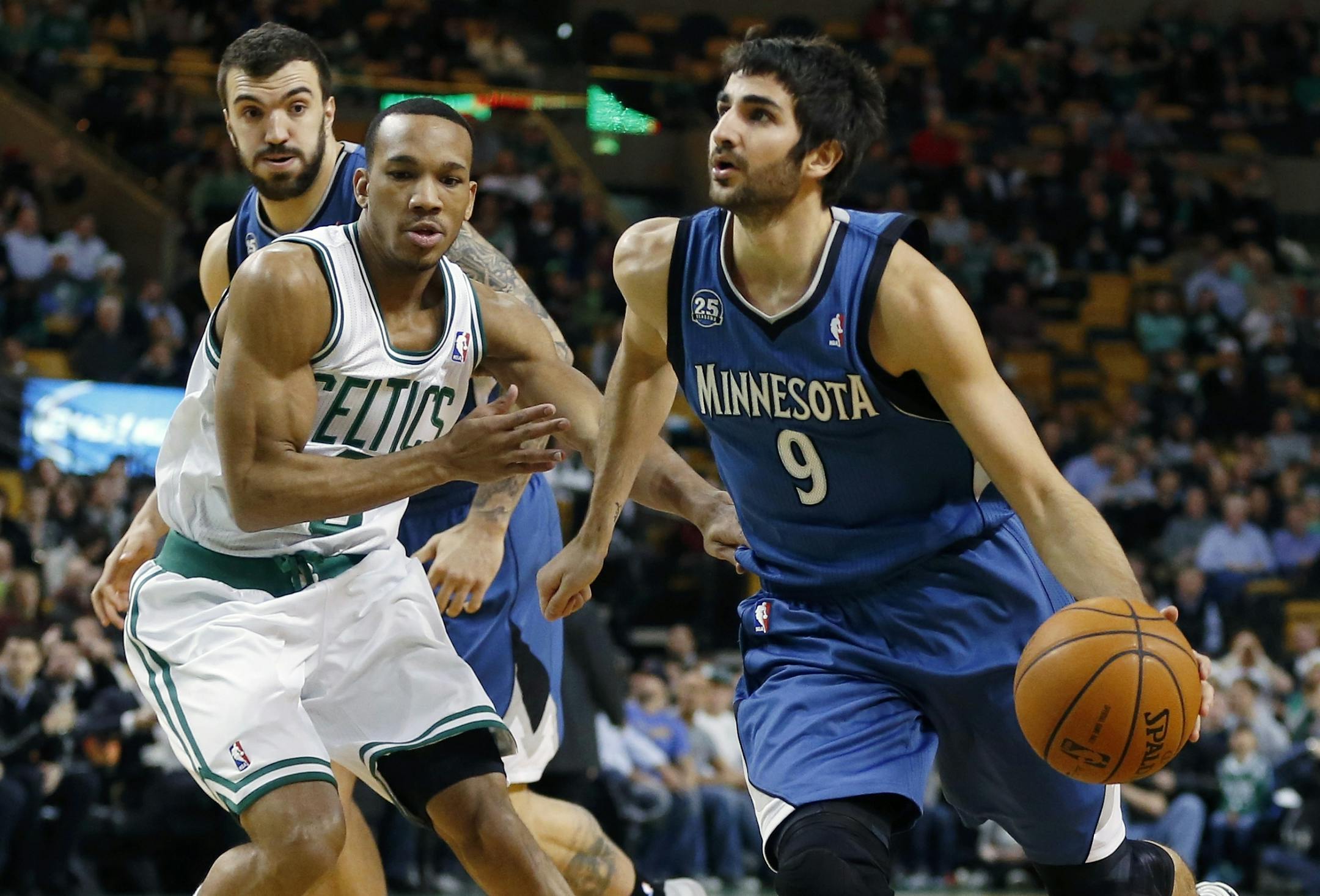 Minnesota Timberwolves' Ricky Rubio (9) drives past Boston Celtics' Avery Bradley (0) in the first quarter of an NBA basketball game in Boston, Monday, Dec. 16, 2013.