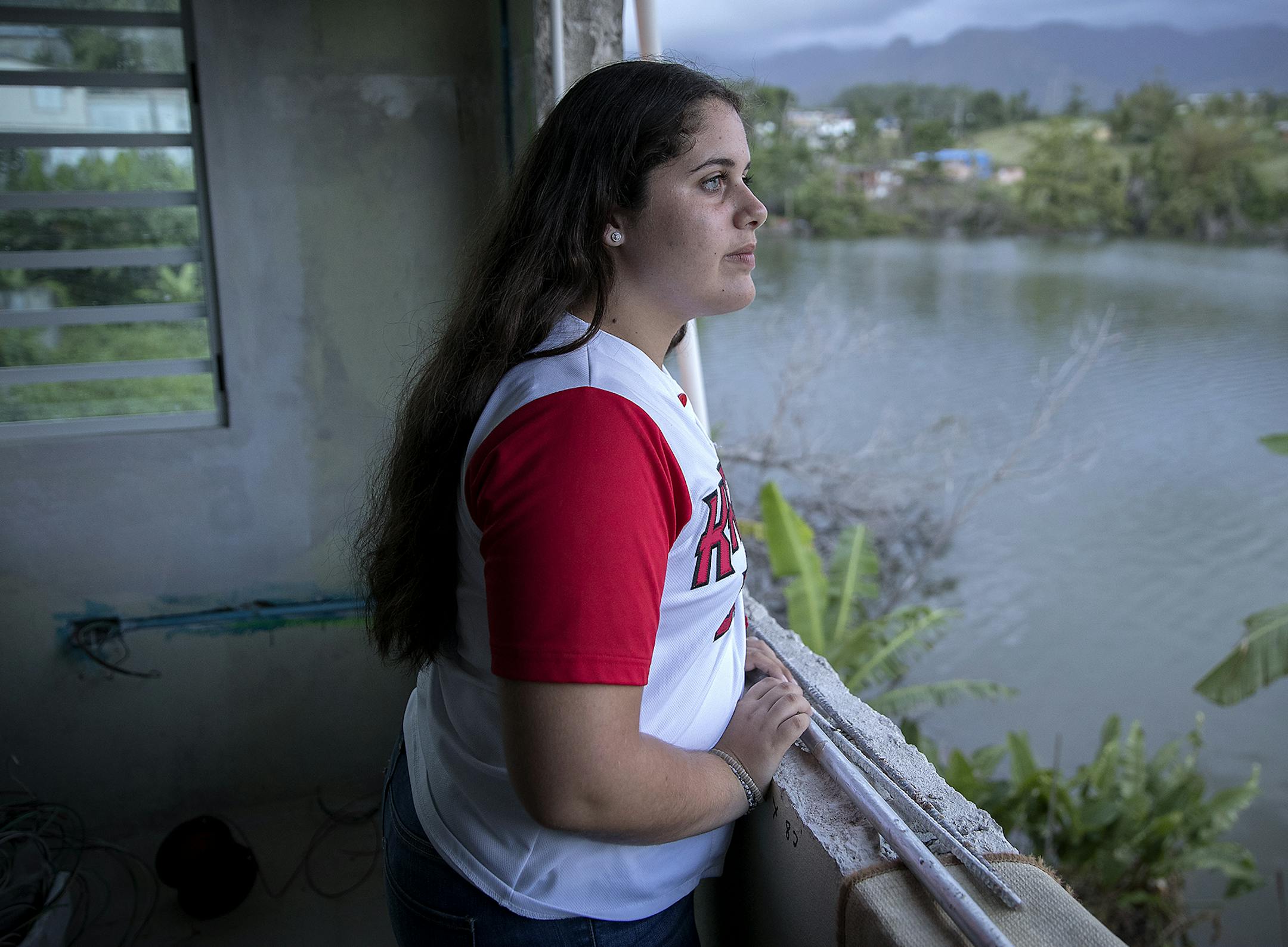 Liz Marie Torres Torres looked out the window that is being fixed after it was destroyed more than seven months ago by Hurricane Maria, Wednesday, April 18, 2018 in Villalba, Puerto Rico.