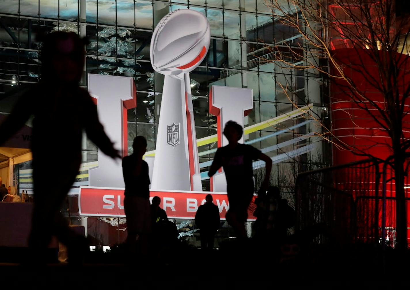 Fans play football outside of the NFL Experience ahead Super Bowl 51 Friday, Feb. 3, 2017, in Houston.