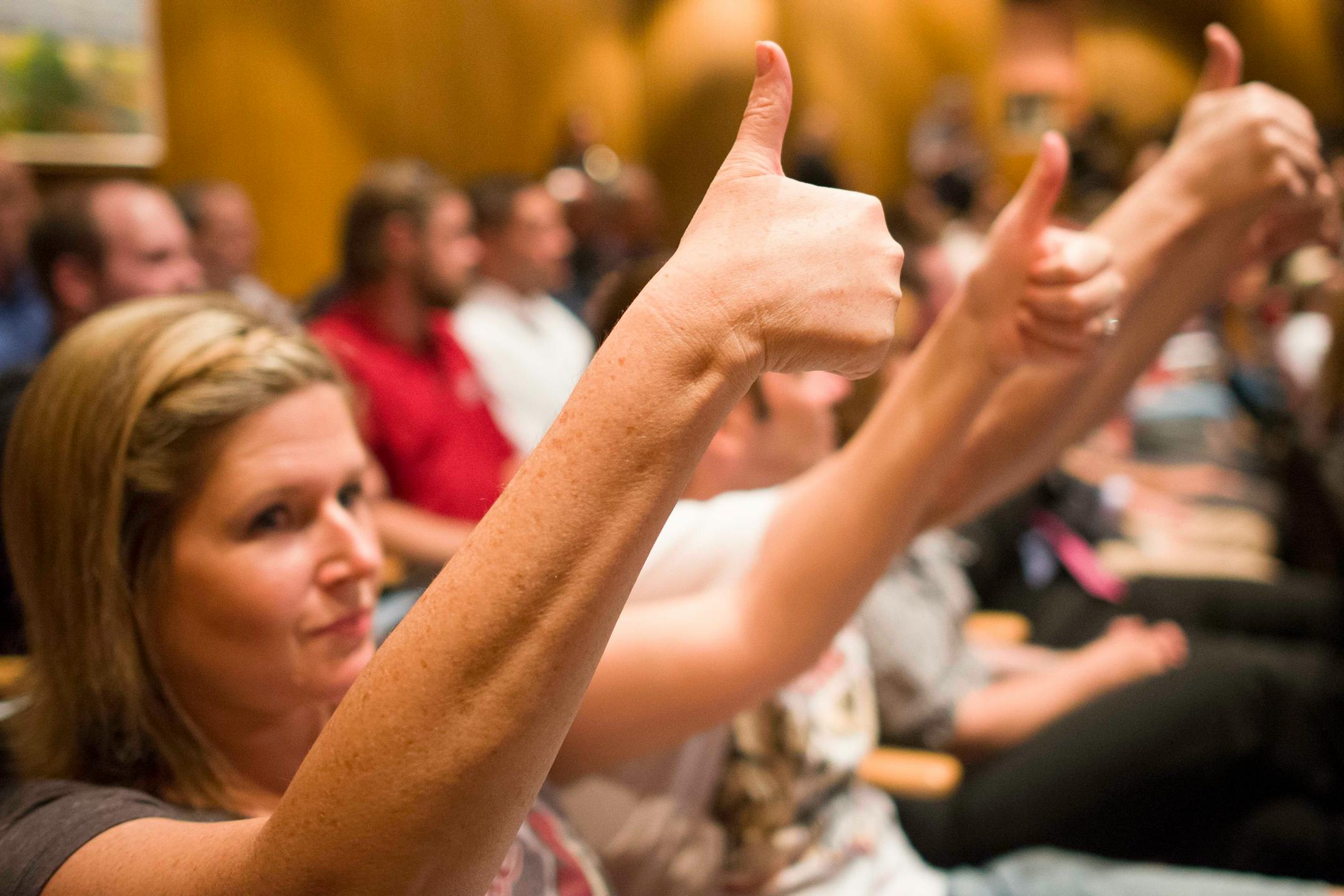 As an alternative to cheering, Kristi Kastenbaum, of Phoenix, gave two thumbs up as NHL Commissioner Gary Bettman spoke during a Glendale City Council meeting concerning lease of Jobing.com Arena to the Coyotes on Tuesday. The council narrowly approved a new lease with prospective owners.