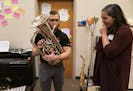 Hmong College Prep Academy band director Roy Pienaar played a baritone that had been donated through Caitlin Marlotte's, right, nonprofit Vega (an org