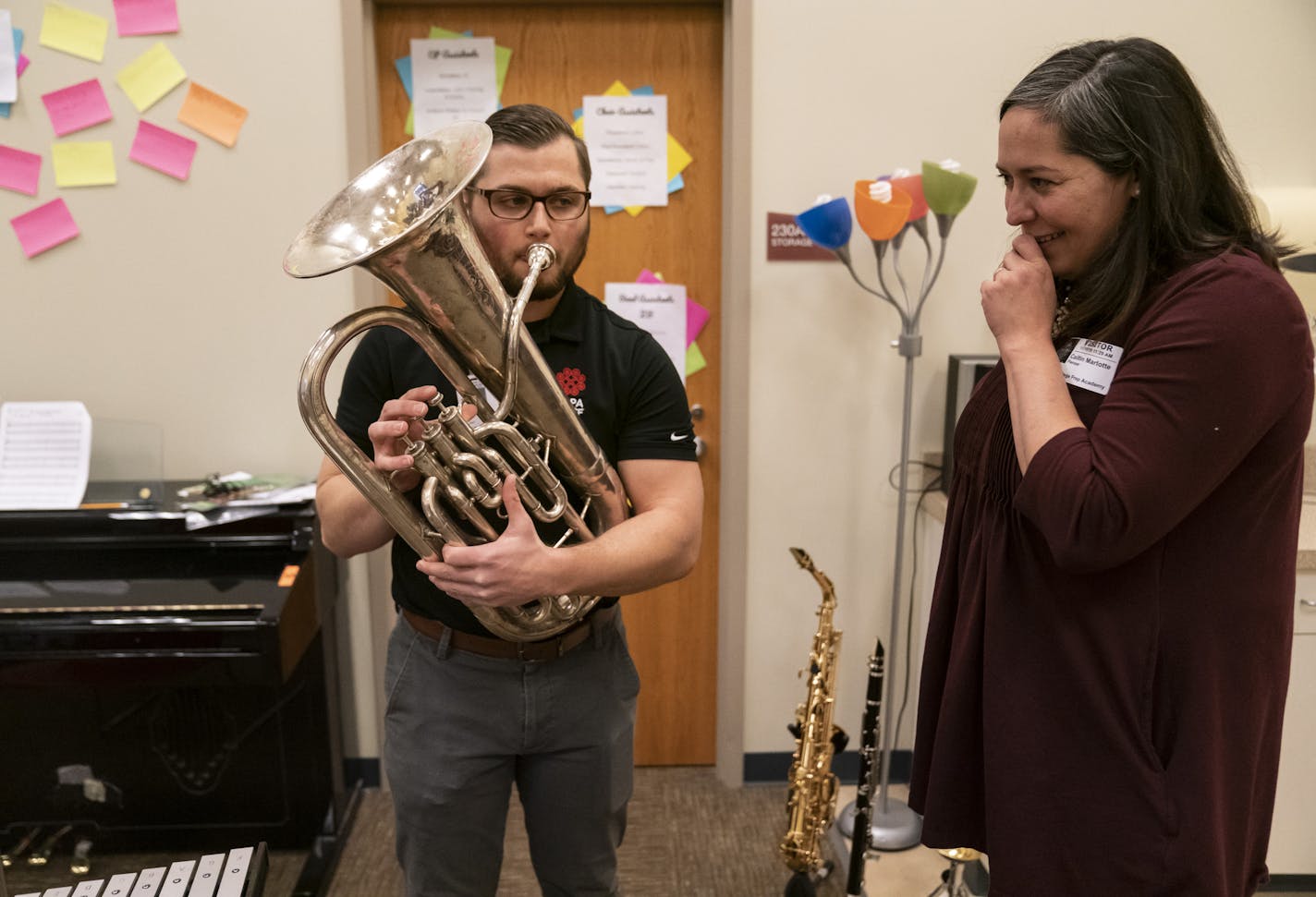 Hmong College Prep Academy band director Roy Pienaar played a baritone that had been donated through Caitlin Marlotte's, right, nonprofit Vega (an organization that collects used band instruments and distributes them to children in need) in St. Paul, Minn., on Friday, November 15, 2019. The baritone came with a note from the owner about how it was beloved by her late husband. ] RENEE JONES SCHNEIDER &#xa5; renee.jones@startribune.com