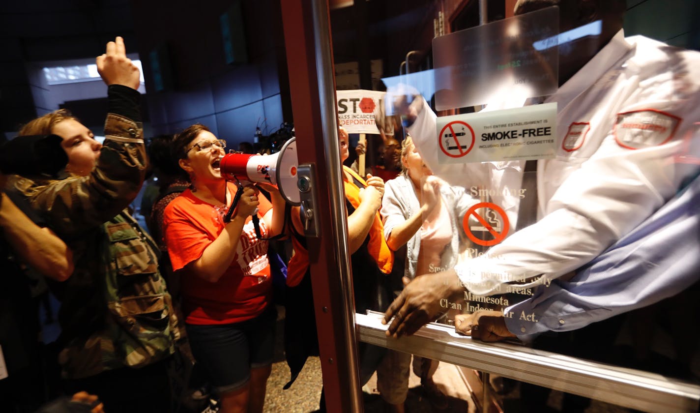 Protesters yelled and crowded a door a security guard was trying to shut after he let in Trump supporters before a fundraiser for republican presidential candidate Donald Trump at the Minneapolis Convention Center on Friday, August 19, 2016 in Minneapolis, Minn. ] RENEE JONES SCHNEIDER &#xef; reneejones@startribune.com