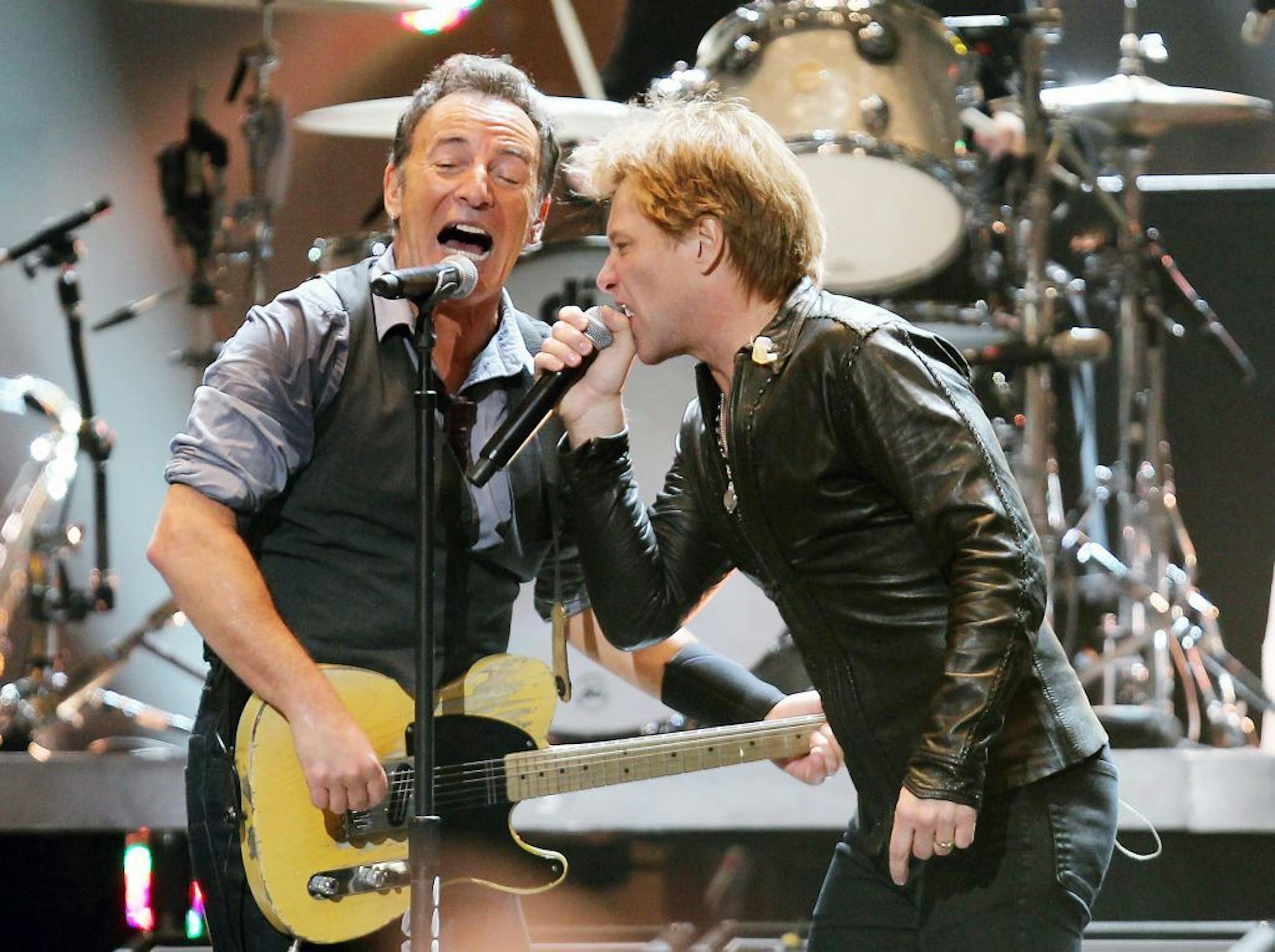 This image released by Starpix shows Jersey boys Bruce Springsteen, left, and Jon Bon Jovi performing at the 12-12-12 The Concert for Sandy Relief at Madison Square Garden in New York on Wednesday, Dec. 12, 2012. Proceeds from the show will be distributed through the Robin Hood Foundation.