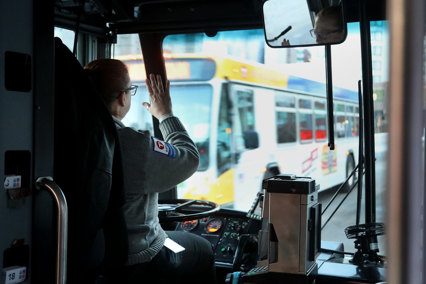 A Metro Transit bus driver heads along her route in downtown Minneapolis and Uptown.