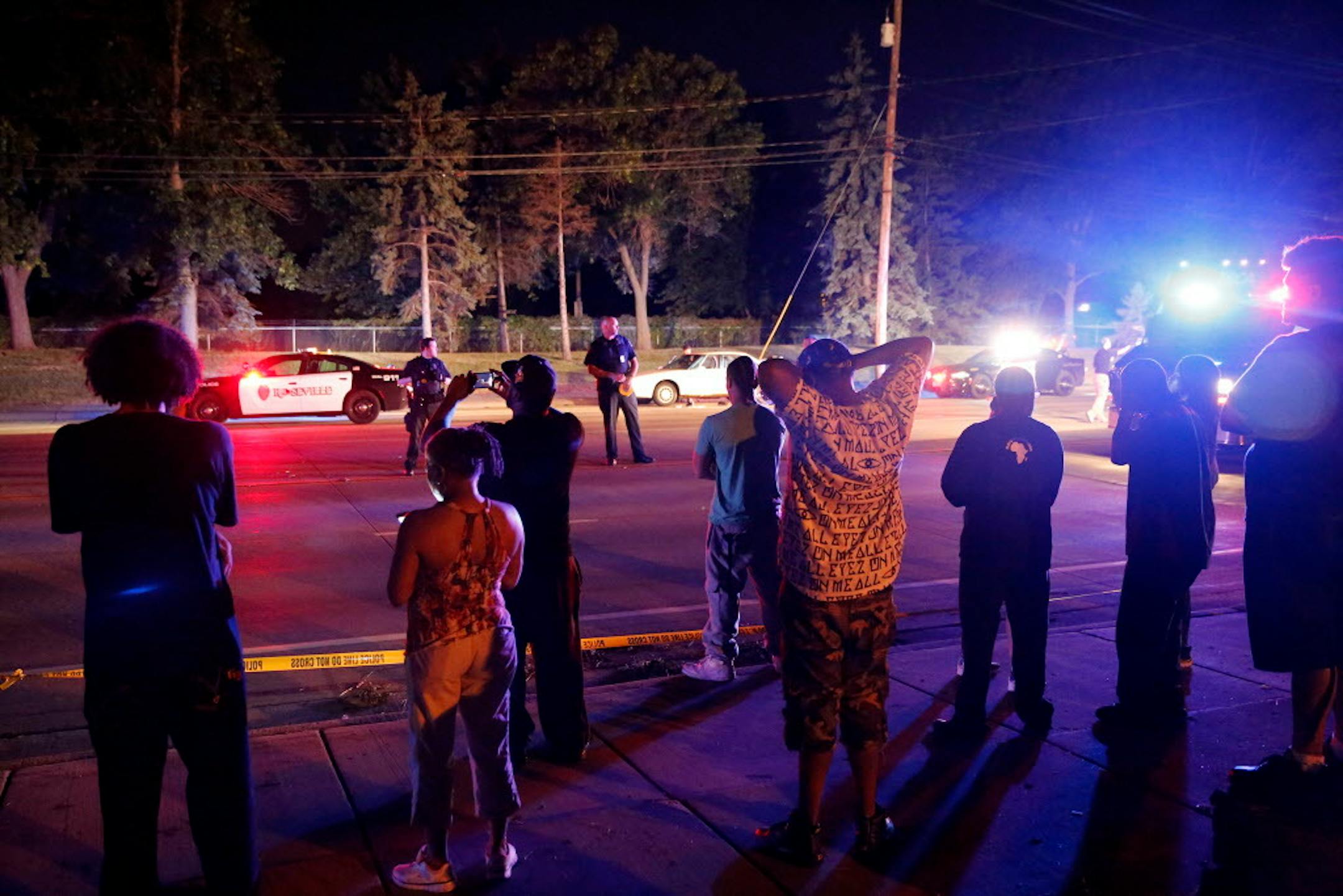 A crowd gathers at the scene of the fatal shooting by a police officer in Falcon Heights on Wednesday, July 6, 2016.