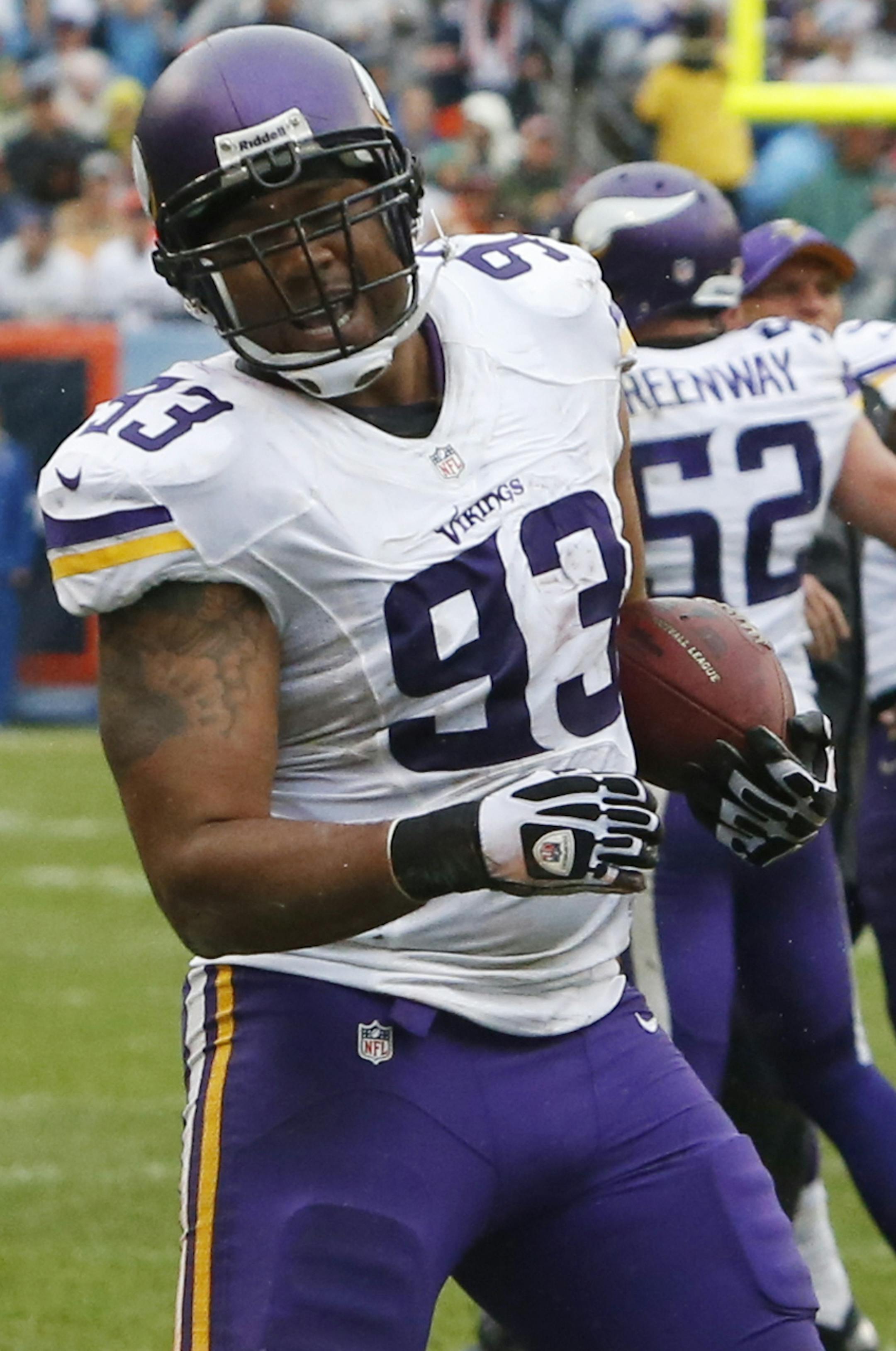Minnesota Vikings defensive tackle Kevin Williams (93) celebrates after intercepting a pass by Chicago Bears quarterback Jay Cutler during the first half of an NFL football game on Sunday, Sept. 15, 2013, in Chicago. (AP Photo/Charles Rex Arbogast)