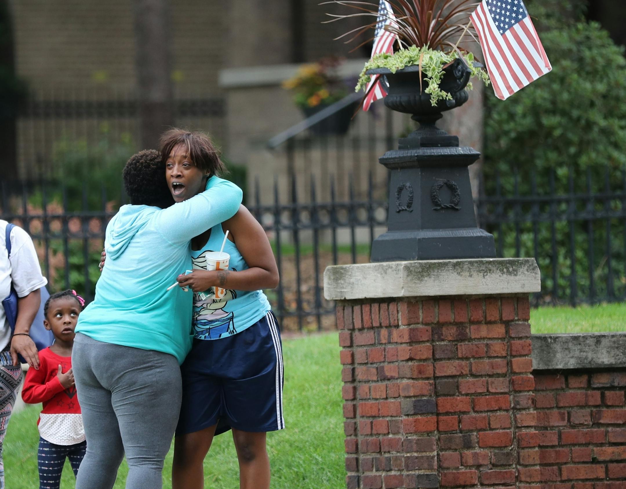 Shouting: "I want justice, I want peace," Diamond Reynolds, the girlfriend of Philando Castile, is hugged by Leigh Ross of Roseville as Reynolds arrives at the protest outside the governor's residence with her child Thursday, July 7, 2016, in St. Paul.