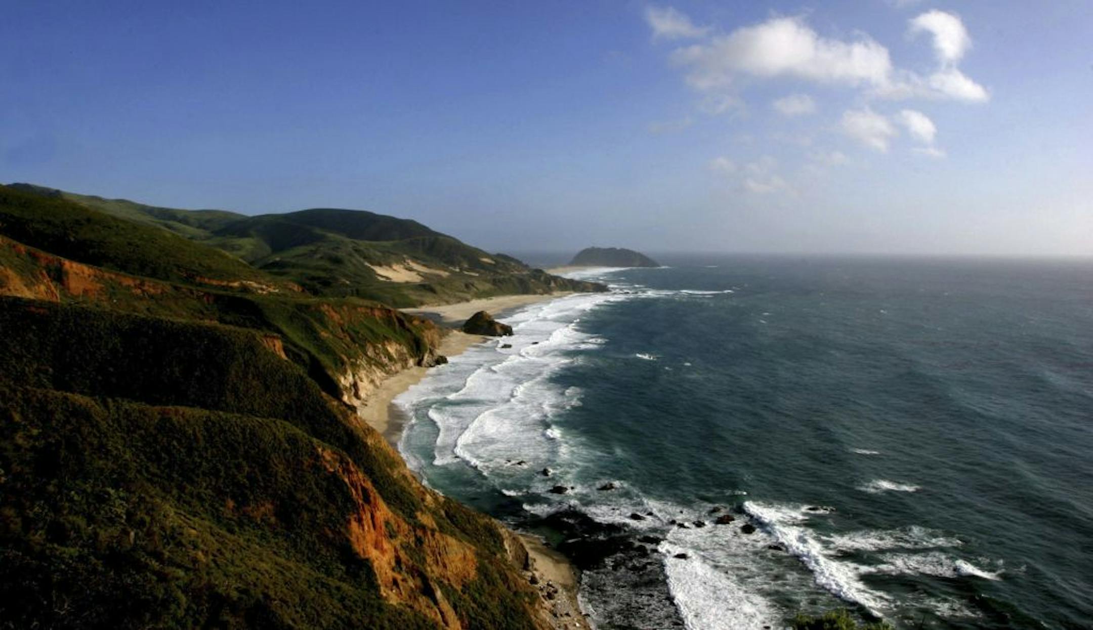 FILE- This April 18, 2005 file photo shows waves as they crash against the cliffs, off of Highway 1, south of Big Sur, Calif. The road to Big Sur is a narrow, winding one, with the Pacific Ocean on one side, spread out like blue glass, and a mountainside of redwoods on the other.