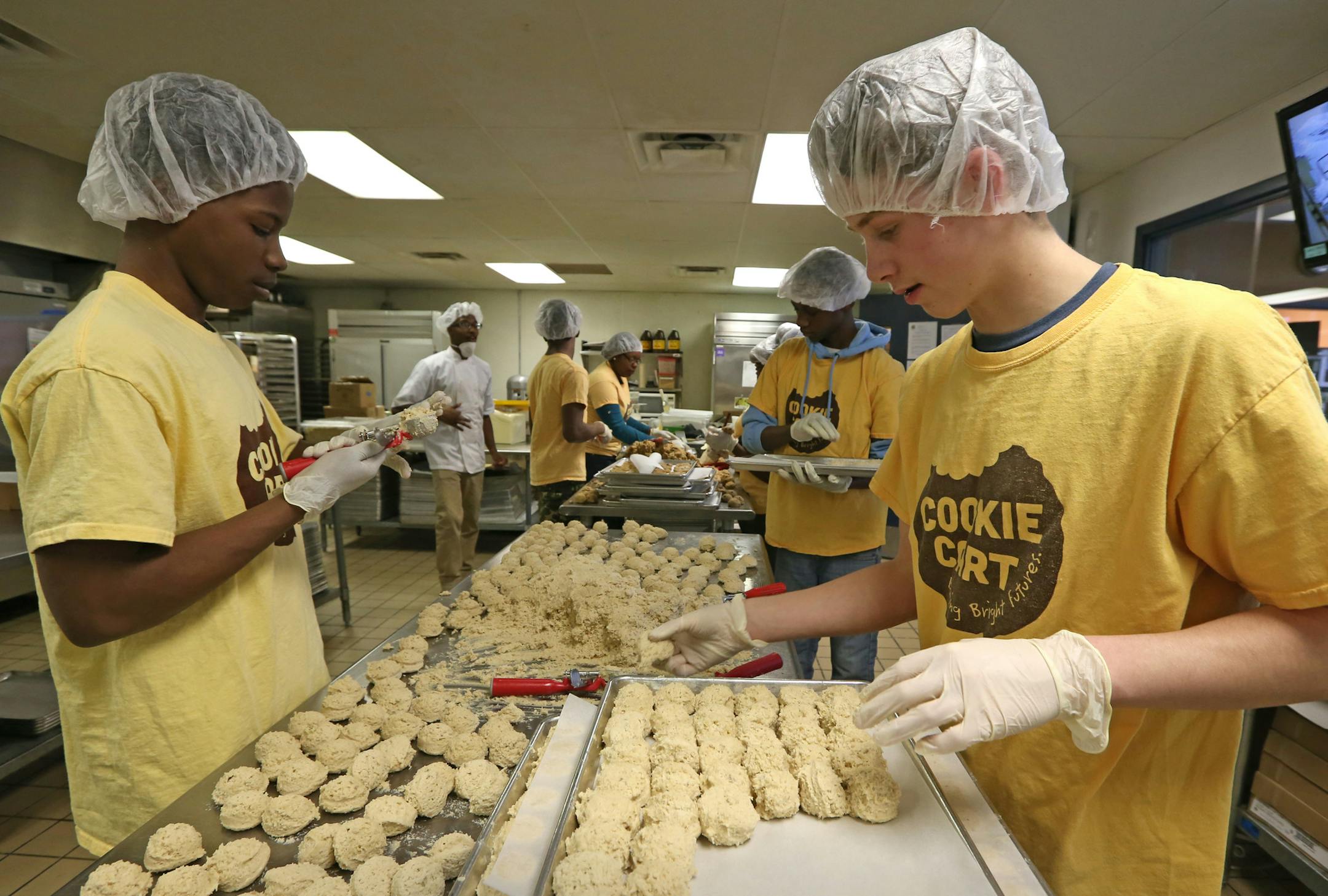 (left to right) Steven Chambers, Omar Pope and Nikos Loman made coconut cookies on 2/6/14, at the Cookie Cart. The Cookie Cart is a fixture of north Minneapolis, a program that teaches high-school kids bakery and life skills.] Bruce Bisping/Star Tribune bbisping@startribune.com Steven Chambers, Omar Pope, Nikos Loman/source.