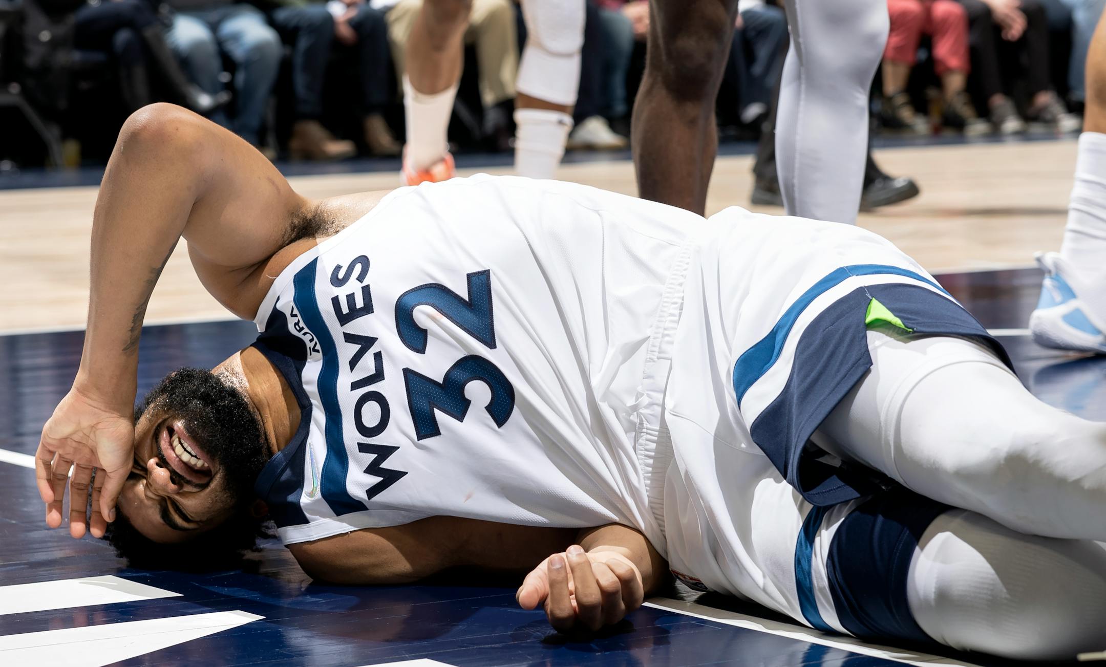 Karl Anthony-Towns (32) of the Minnesota Timberwolves winces in pain after being fouled in the first quarter.