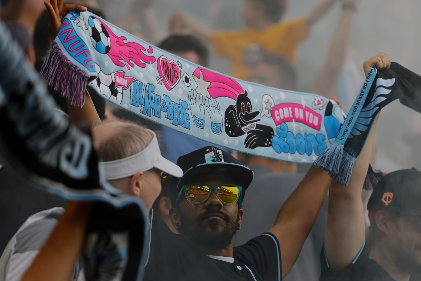 A Minnesota United fan celebrates a goal during the first half of the team's Leagues Cup soccer match against Toluca on Tuesday, Aug. 8, 2023, in St. Paul, Minn. Minnesota advanced on penalty kicks. (AP Photo/Bruce Kluckhohn)