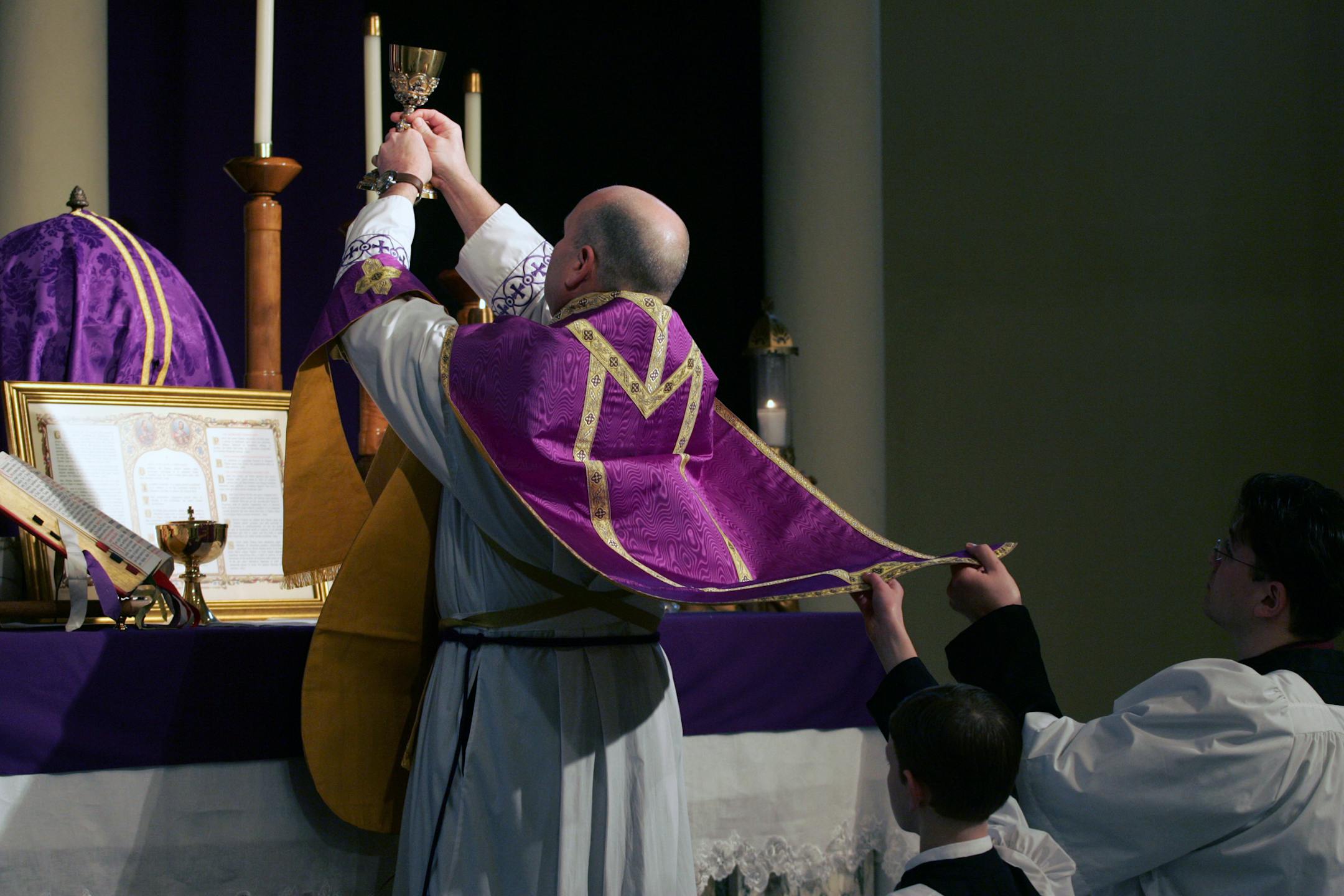 Fr. John Echert, left, performed a noon mass in Latin at Holy Trinity Catholic Church. Assisting him are acolytes Joe Manders, center, and David Dvorak, right.