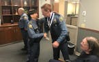 Assistant Chief Kathy Wuorinen congratulates Officer Alexander Graham, right, for earning two Lifesaving Awards on Wednesday, Aug. 29, 2018.