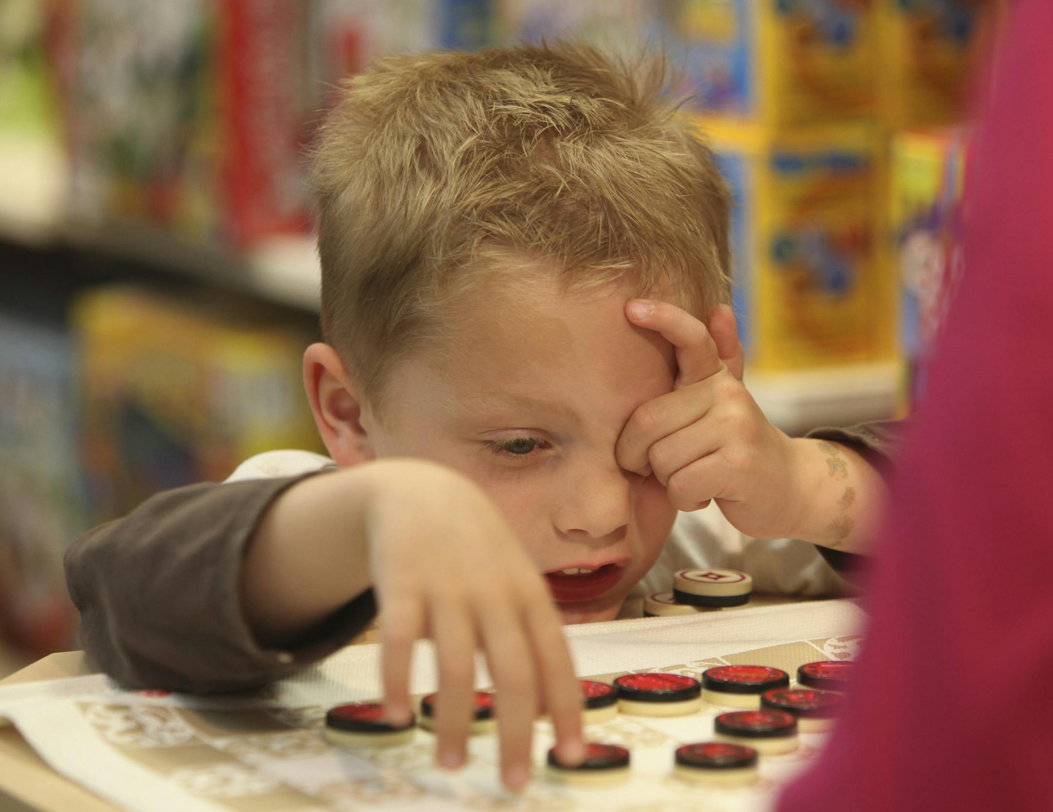 Barb Cianca, of Arden Hills, played checkers with her grandson, Aaron Cianca, 5, of Mounds View, who was celebrating his birthday Thursday was picking out a birthday present for himself at Creative Kidstuff in St Paul Min., Thursday, April 12, 2012. Creative Kidstuff was one of the local businesses that supported the E-Fairness legislation this session. ] (KYNDELL HARKNESS/STAR TRIBUNE) kyndell.harkness@startribune.com ORG XMIT: MIN2013050817410527