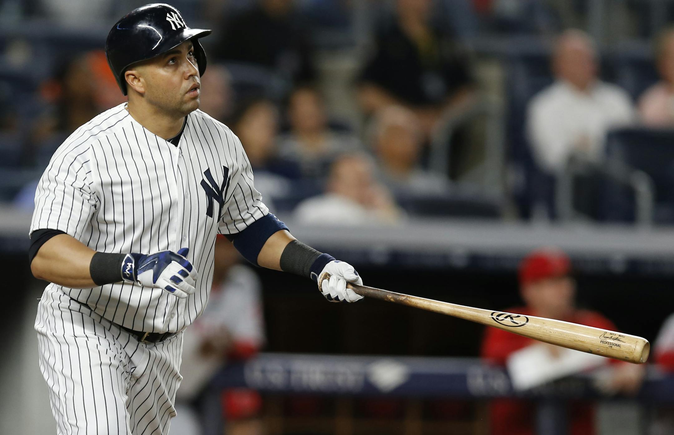 New York Yankees right fielder Carlos Beltran (36) watches his eight-inning, three-run home run clear the right field wall during a baseball game against the Los Angeles Angels at Yankee Stadium in New York, Monday, June 6, 2016. (AP Photo/Kathy Willens)